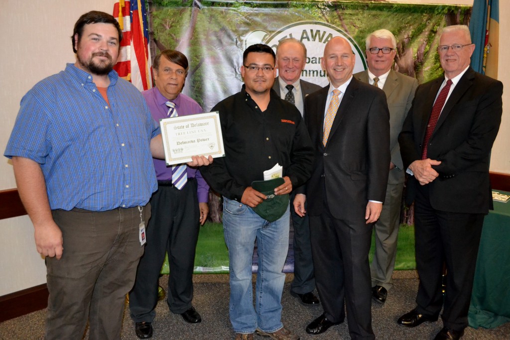 (from left) Michael Krzyzanowski of Delmarva Power receives the Tree Line USA Award joined by Dover Mayor Robin Christiansen, George Vasquez of Asplundh Tree Expert Company, Rep. David L. Wilson, Gov. Jack Markell, Sec. of Agriculture Ed Kee, and Rep. Harvey Kenton. 